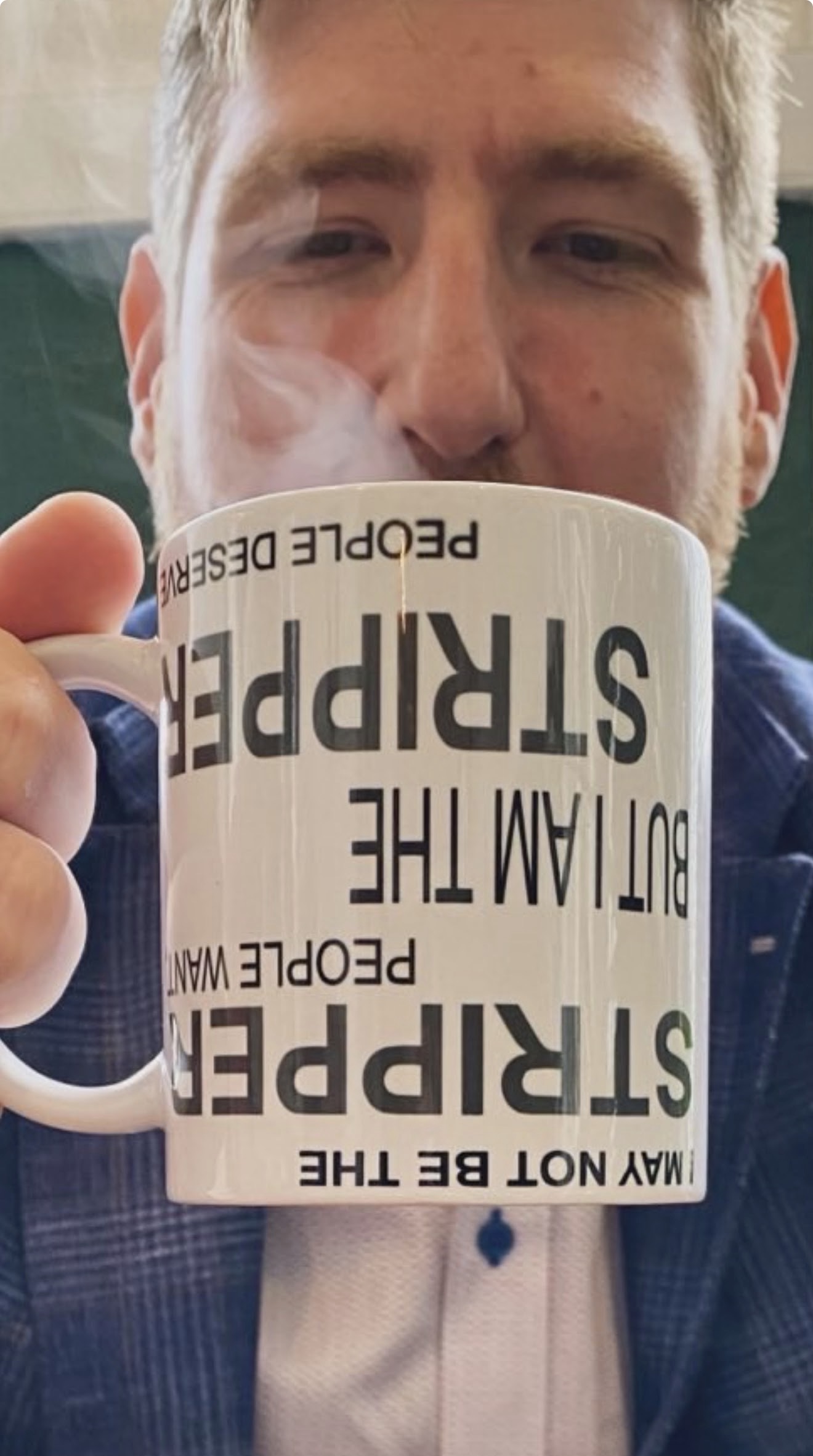 Stripper Mug held up showing the text clearly