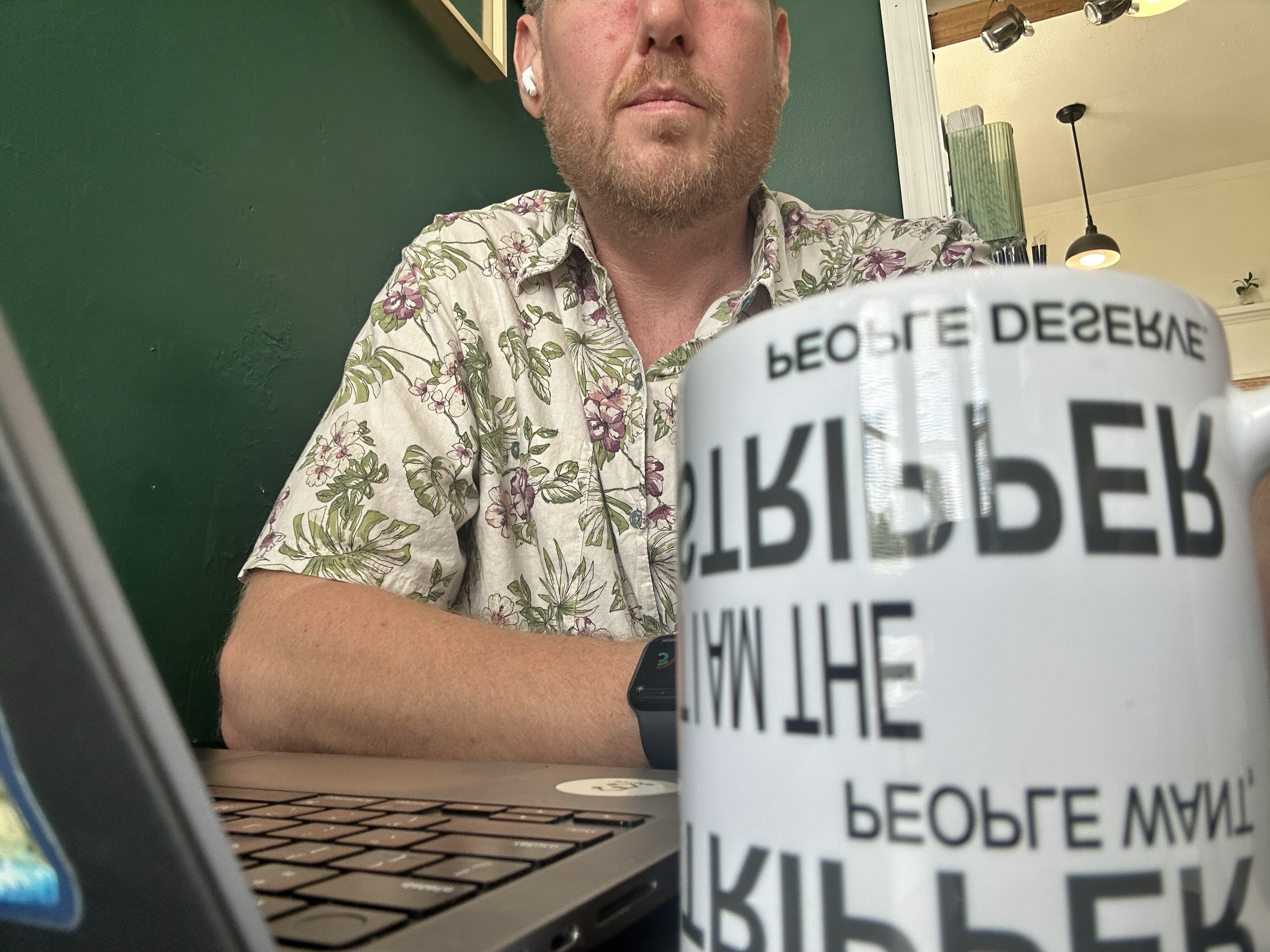 Stripper Mug on desk showing upside down text